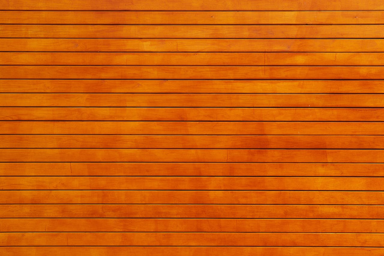 Close-up of a vibrant orange wooden wall texture, ideal for backgrounds.